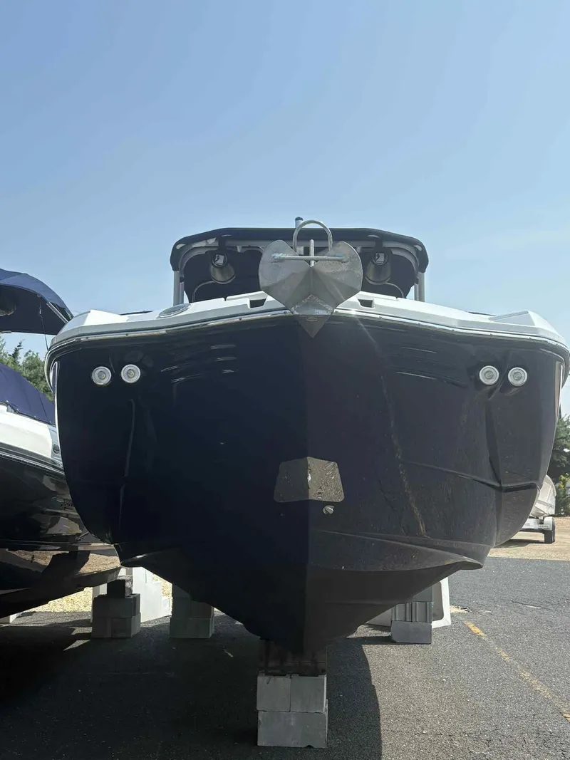 Slide: The Image of 2023 Monterey M65 boat on blocks, viewed from the front under a clear sky. - 4