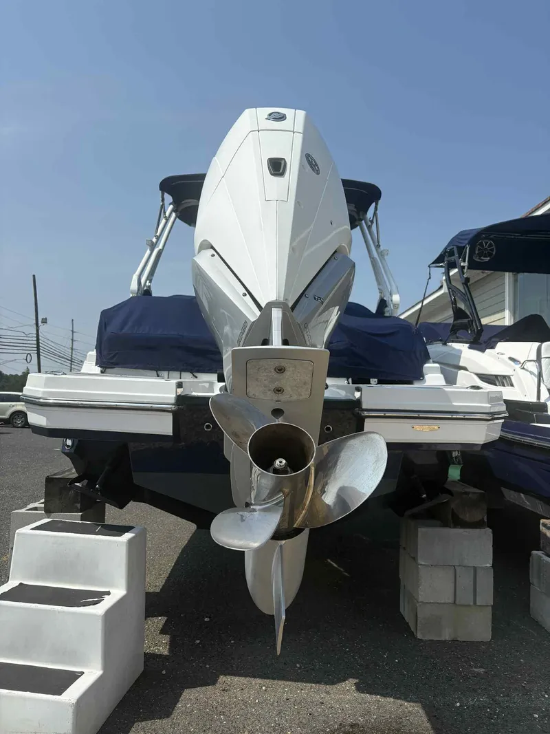 Slide: The Image of 2023 Monterey M65 boat on blocks, rear view with propeller visible. - 6