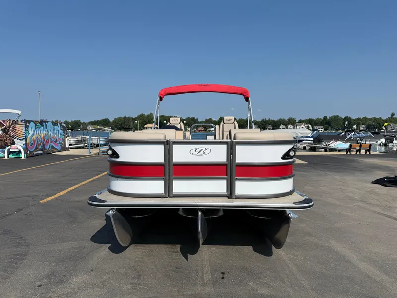 Slide: The Image of 2026 Bentley Pontoons Legacy 223 Navigator at marina, red and white design, sunny day. - 1