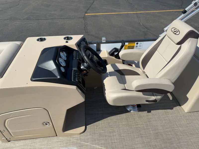 Slide: The Image of 2026 Bentley Pontoons Legacy 223 Navigator helm with beige captain's chair and dashboard. - 13