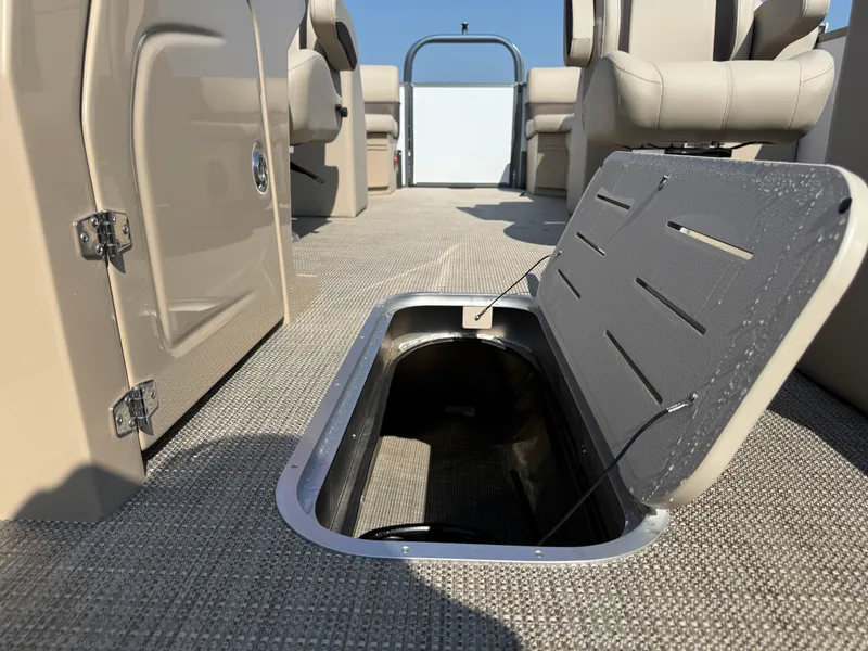 Slide: The Image of 2026 Bentley Pontoons Legacy 223 Navigator interior with open storage compartment. - 23