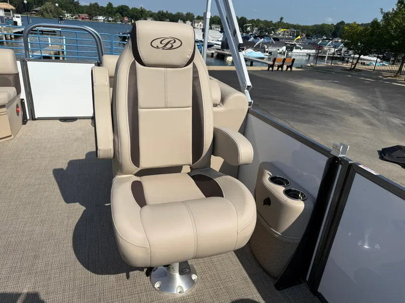Slide: The Image of 2026 Bentley Pontoons Legacy 223 Navigator captain's chair with cup holders, docked at marina. - 25