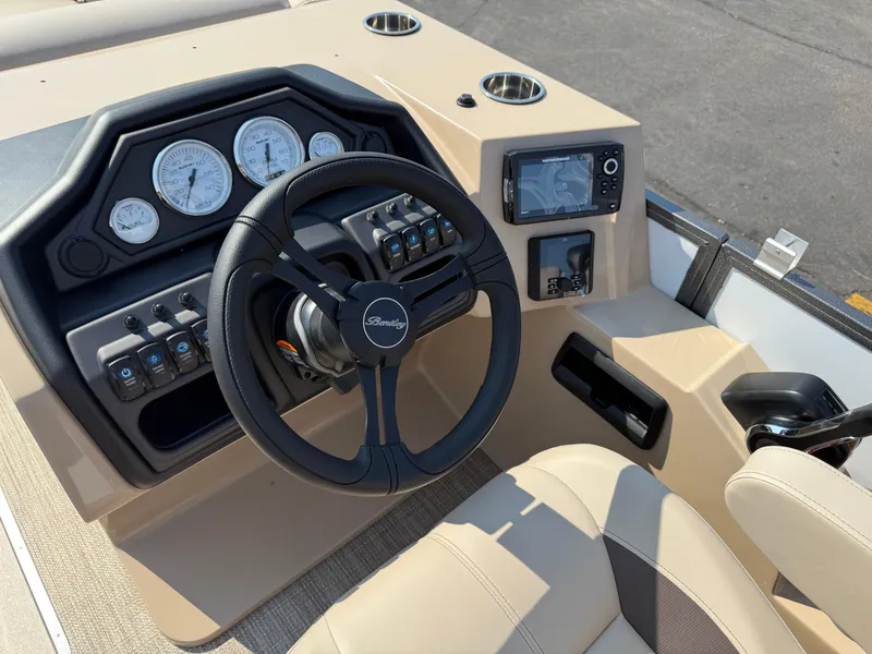 Slide: The Image of 2026 Bentley Pontoons Legacy 223 Navigator dashboard with steering wheel and navigation controls. - 28