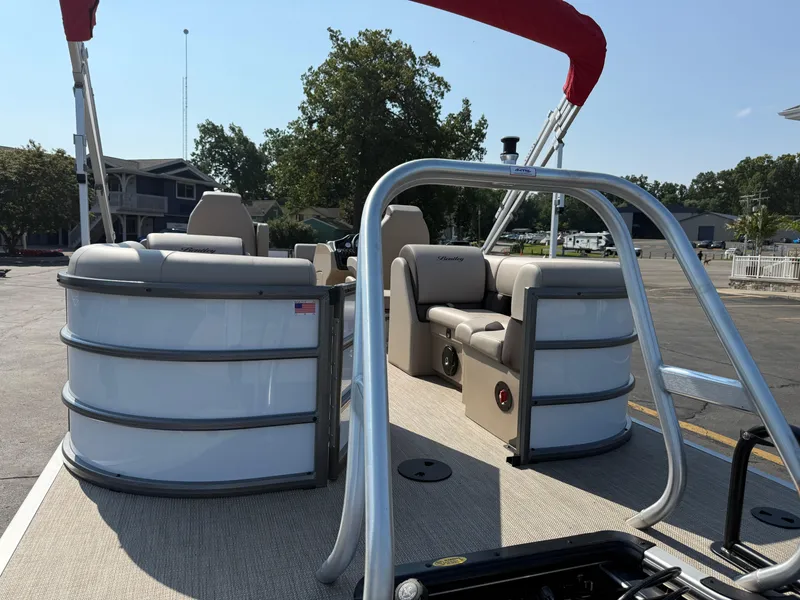 Slide: The Image of 2026 Bentley Pontoons Legacy 223 Navigator with seating and canopy, docked outdoors. - 3