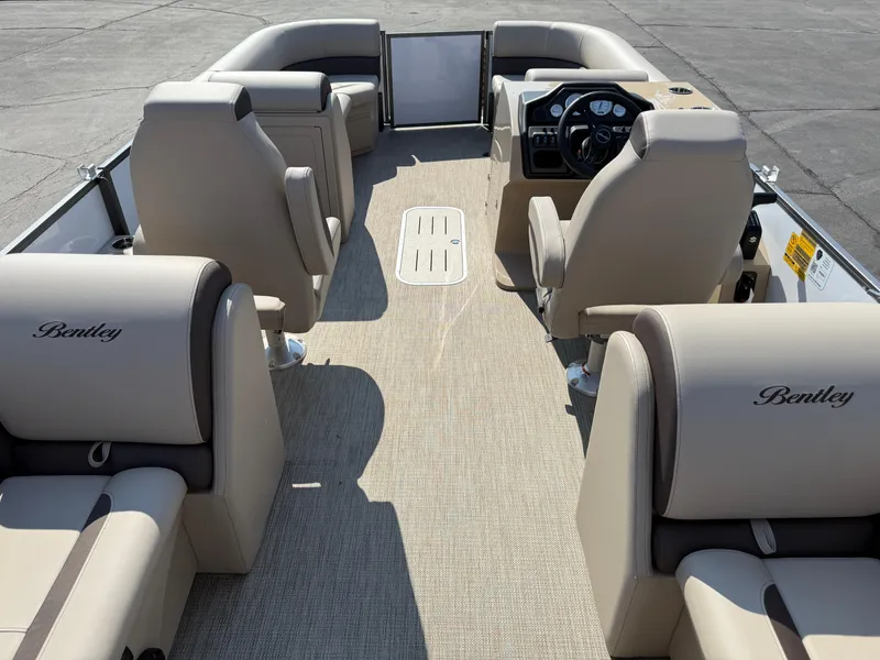 Slide: The Image of 2026 Bentley Pontoons Legacy 223 Navigator interior with beige seating and steering console. - 35