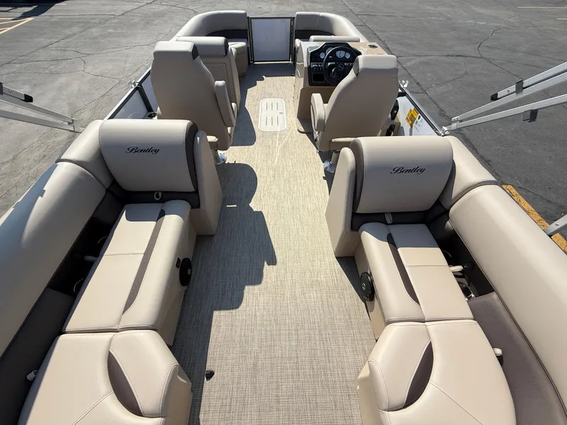 Slide: The Image of 2026 Bentley Pontoons Legacy 223 Navigator interior with beige seating and steering console. - 36