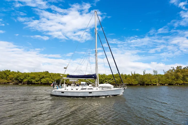 Slide: The Image of Sailing yacht Hylas 46 (2004) cruising on a sunny day with lush greenery background. - 1