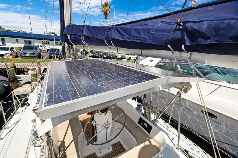 Slide: The Image of Sailboat with solar panel, Hylas 46 model, 2004, docked at marina under blue sky. - 12