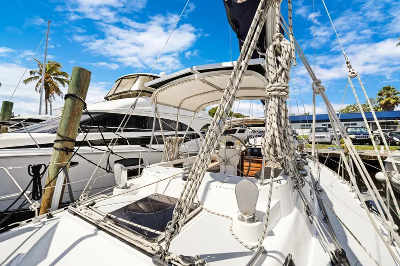 Slide: The Image of Sailboat docked at marina, Hylas 46 model, 2004, with clear blue sky background. - 15