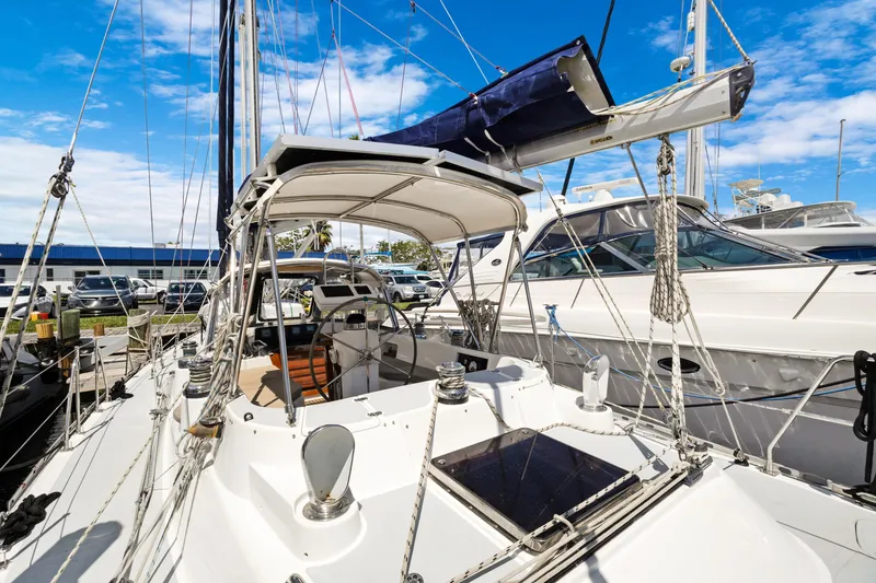 Slide: The Image of 2004 Hylas 46 sailboat docked, showcasing cockpit and rigging under clear blue sky. - 17