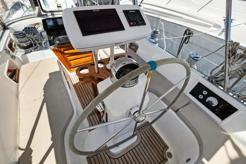 Slide: The Image of Cockpit of 2004 Hylas 46 sailboat with steering wheel and navigation equipment. - 23