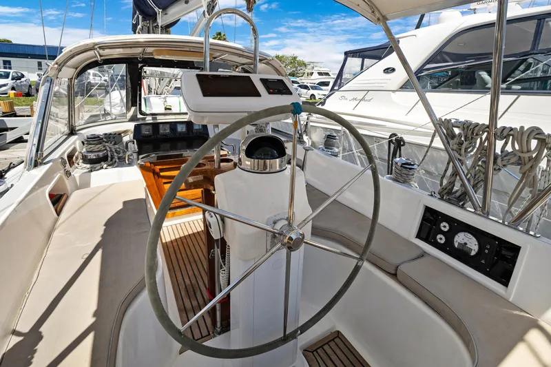 Slide: The Image of Cockpit of a 2004 Hylas 46 sailboat with steering wheel and navigation instruments. - 24