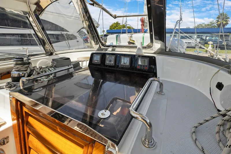 Slide: The Image of Cockpit of 2004 Hylas 46 sailboat with navigation instruments and polished wood details. - 28