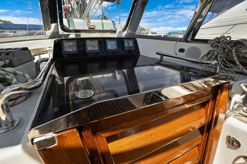 Slide: The Image of Cockpit of 2004 Hylas 46 sailboat with navigation instruments and polished wood finish. - 29