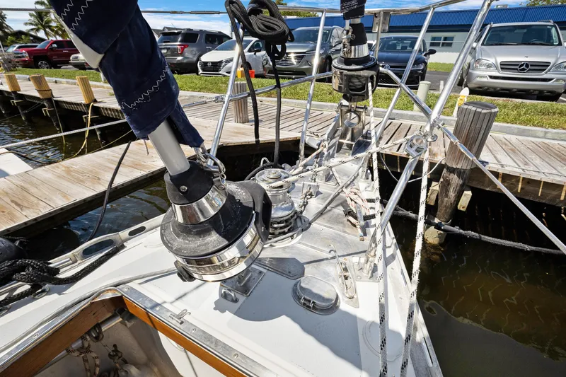 Slide: The Image of Deck of a 2004 Hylas 46 sailboat docked, featuring winches and rigging. - 3