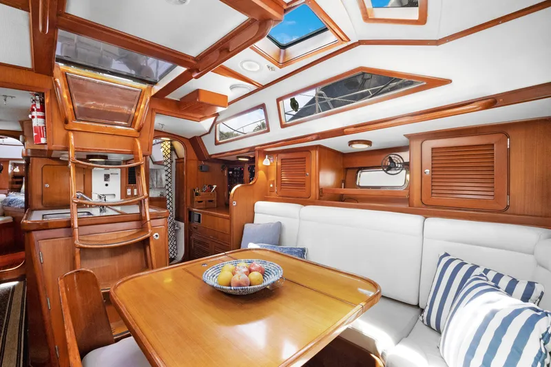 Slide: The Image of Luxurious interior of a 2004 Hylas 46 yacht with wooden finishes and comfortable seating. - 32