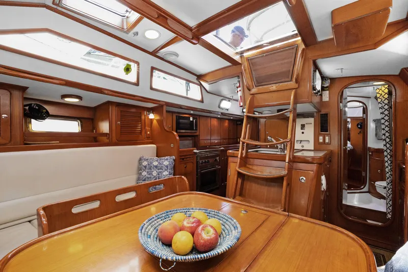 Slide: The Image of Interior of 2004 Hylas 46 yacht with wooden finish and dining area. - 33