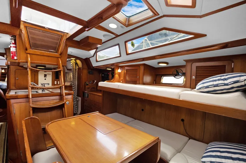 Slide: The Image of Interior of 2004 Hylas 46 yacht with wooden furnishings and cozy seating area. - 37