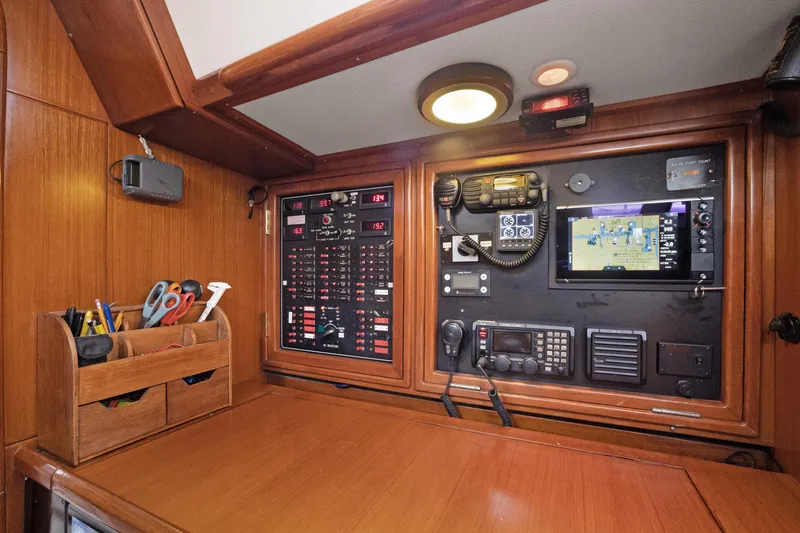 Slide: The Image of Navigation station of a 2004 Hylas 46 yacht with control panels and tools. - 42
