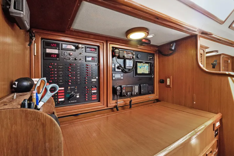Slide: The Image of Navigation station on a 2004 Hylas 46 yacht with control panels and equipment. - 43