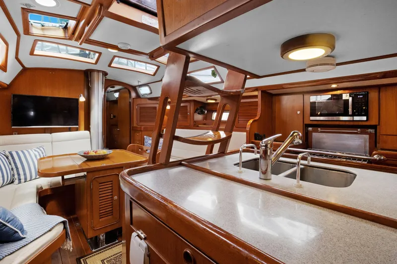 Slide: The Image of Luxurious interior of 2004 Hylas 46 yacht with modern kitchen and cozy seating area. - 44