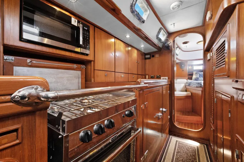 Slide: The Image of Luxurious 2004 Hylas 46 yacht interior with wood finish and modern kitchen amenities. - 46