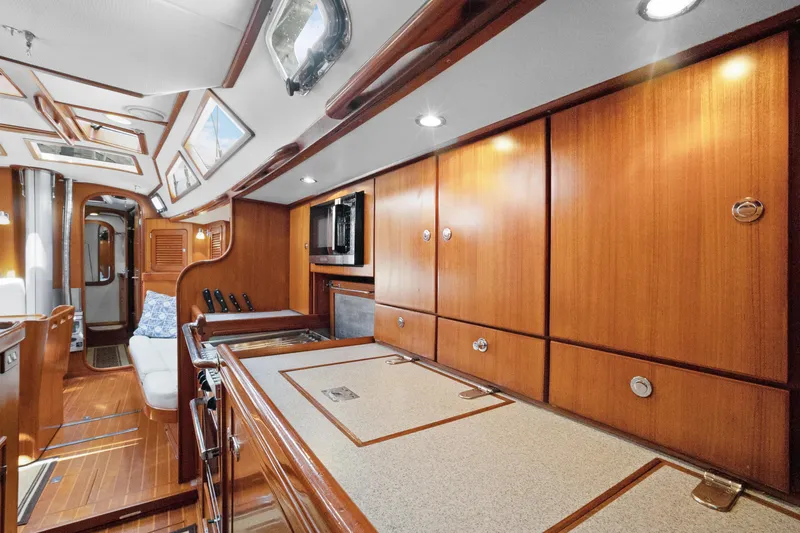 Slide: The Image of Luxurious 2004 Hylas 46 yacht interior with elegant wood cabinetry and modern amenities. - 50