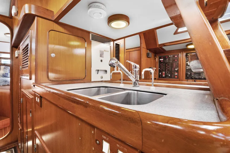 Slide: The Image of Luxurious 2004 Hylas 46 yacht interior with modern kitchen and wooden cabinetry. - 52