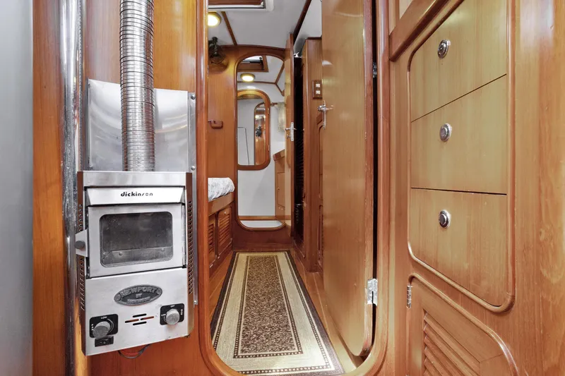 Slide: The Image of Interior of 2004 Hylas 46 yacht with wood paneling and Dickinson heater. - 53