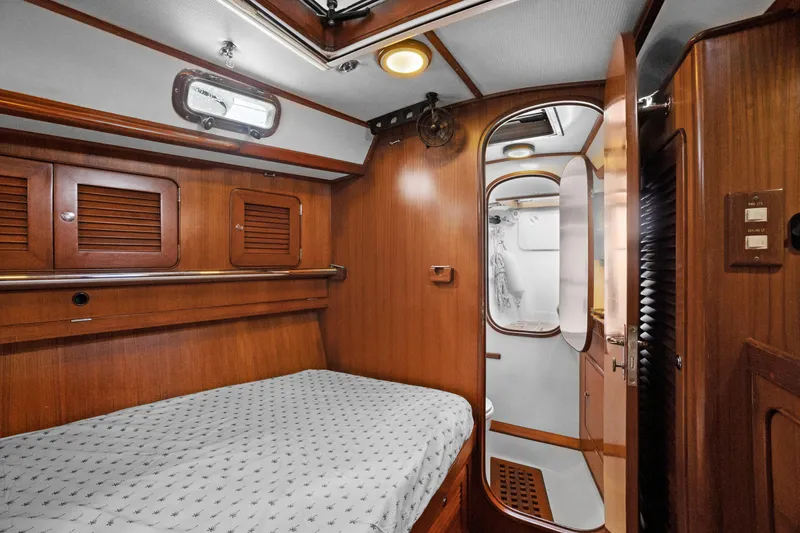 Slide: The Image of Cozy cabin interior of 2004 Hylas 46 yacht with wooden finish and bed. - 54