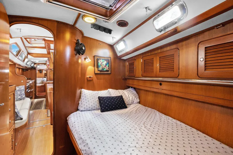 Slide: The Image of Cozy cabin interior of 2004 Hylas 46 yacht with wooden finish and comfortable bedding. - 56