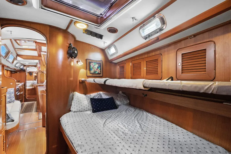 Slide: The Image of Interior of 2004 Hylas 46 yacht with cozy wooden cabin and comfortable bedding. - 57