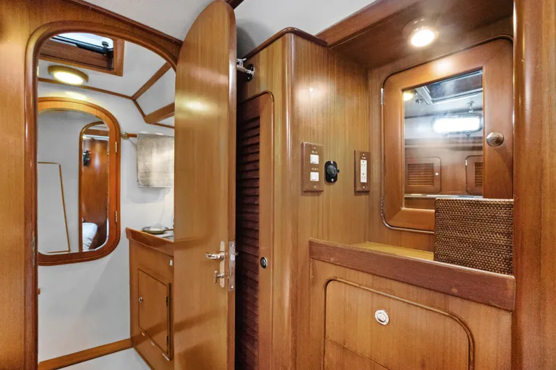 Slide: The Image of Interior of 2004 Hylas 46 yacht featuring wooden cabinetry and modern lighting. - 59