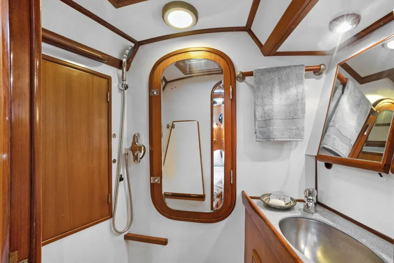 Slide: The Image of Luxurious 2004 Hylas 46 yacht bathroom with wood accents and modern fixtures. - 61