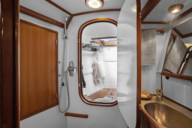 Slide: The Image of Luxurious bathroom interior of a 2004 Hylas 46 yacht, featuring wood accents and modern fixtures. - 63