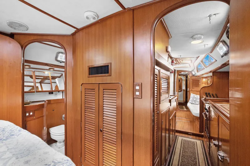 Slide: The Image of Interior of 2004 Hylas 46 yacht featuring wood paneling and cozy living space. - 65