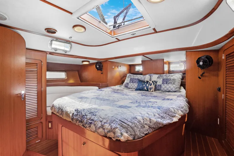 Slide: The Image of Luxurious cabin interior of 2004 Hylas 46 yacht with skylight and cozy bedding. - 66