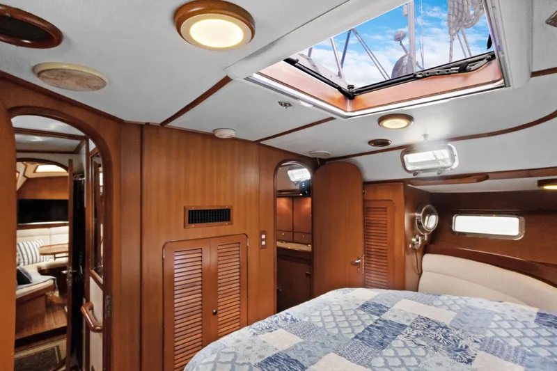Slide: The Image of Luxurious interior of a 2004 Hylas 46 yacht with wood paneling and skylight. - 67