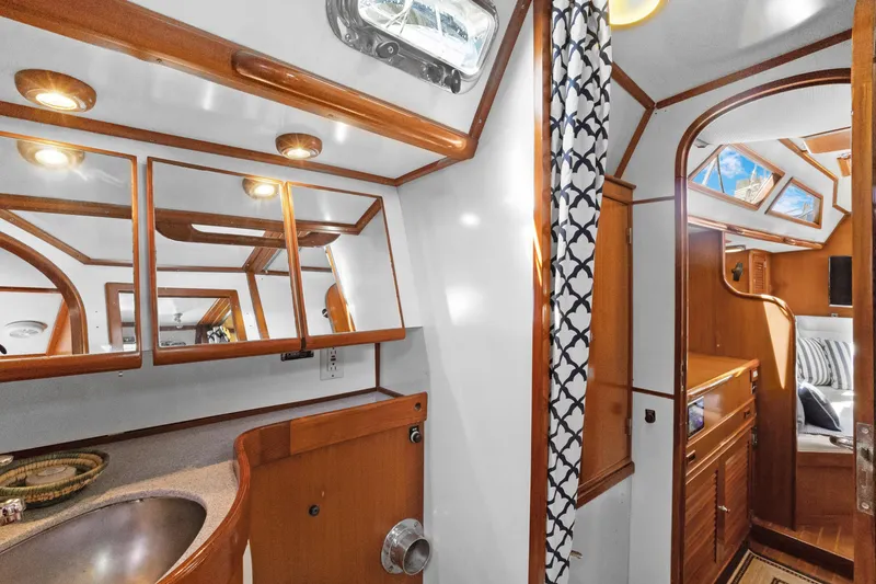 Slide: The Image of Luxurious 2004 Hylas 46 yacht interior with wood accents and modern amenities. - 69