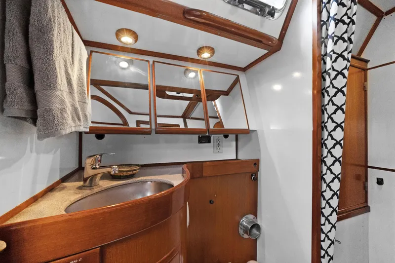 Slide: The Image of Luxurious 2004 Hylas 46 yacht bathroom with wood accents and modern fixtures. - 70