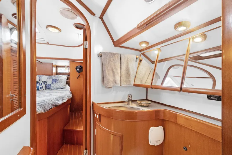 Slide: The Image of Luxurious 2004 Hylas 46 yacht interior with wooden cabinetry and cozy bedroom. - 71