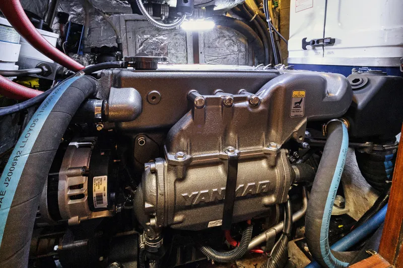 Slide: The Image of Engine compartment of a 2004 Hylas 46 yacht featuring a Yanmar engine. - 74