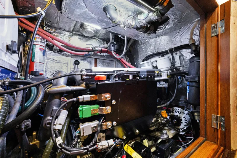 Slide: The Image of Engine room of a 2004 Hylas 46 yacht, showcasing complex wiring and components. - 77