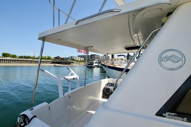 Slide: The Image of 2002 Bayliner 3988 yacht docked in a marina, showcasing sleek design and spacious deck. - 11