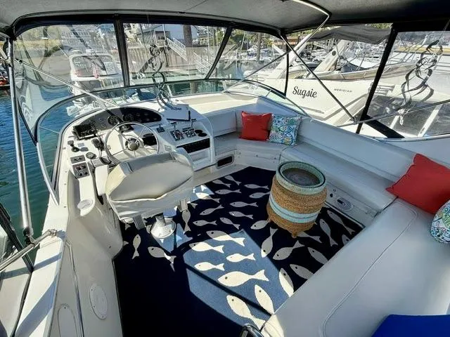 Slide: The Image of 2002 Bayliner 3988 boat interior with helm, seating, and nautical-themed decor. - 20