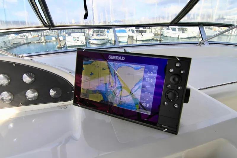 Slide: The Image of Bayliner 3988 (2002) helm with Simrad navigation display, docked at marina. - 22