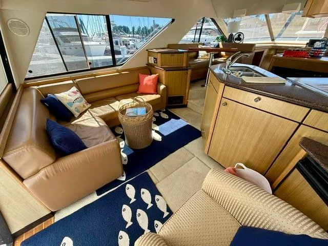 Slide: The Image of Luxurious 2002 Bayliner 3988 yacht interior with cozy seating and modern kitchen area. - 29
