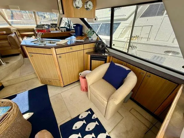 Slide: The Image of Interior of 2002 Bayliner 3988 yacht with cozy seating and modern kitchen area. - 31