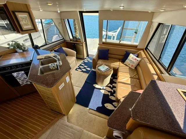 Slide: The Image of Luxurious interior of 2002 Bayliner 3988 yacht with spacious seating and modern kitchen. - 32