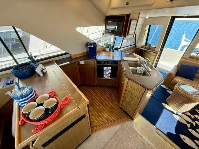 Slide: The Image of Luxurious 2002 Bayliner 3988 yacht interior with modern kitchen and ocean view. - 34